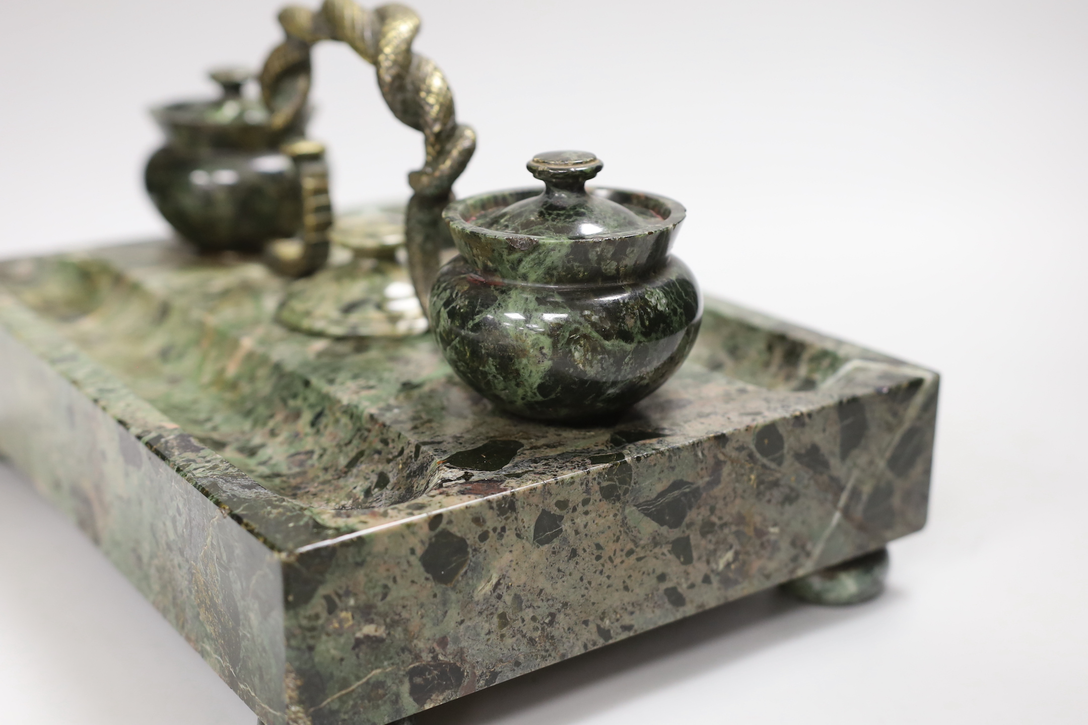 A 19th century green marble inkstand, with brass snake handle, 33cm wide, 23cm deep